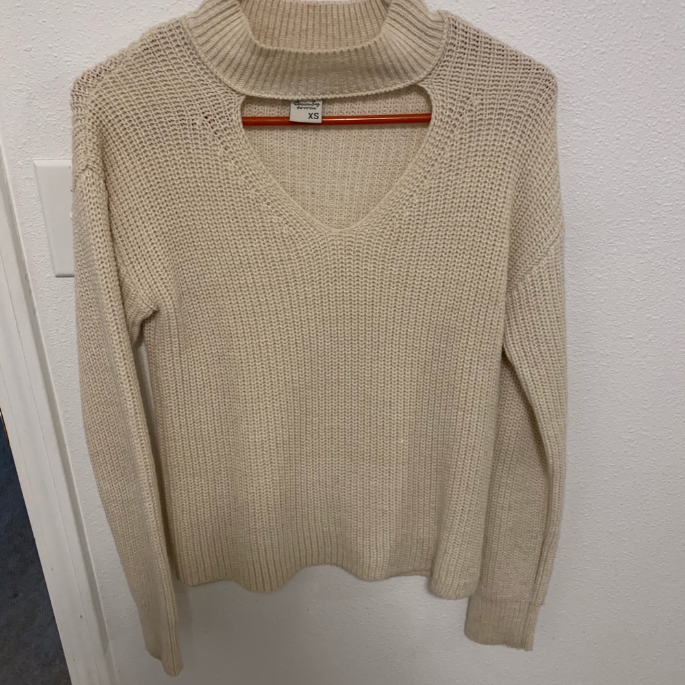 Long sleeve tan knit sweater with peep hole